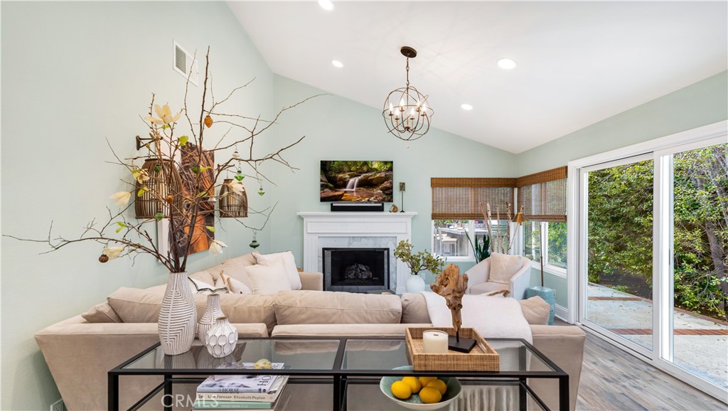6 Mallard Irvine, CA 92604 - Photo 15 of 45 a living room with furniture chandelier and a fireplace