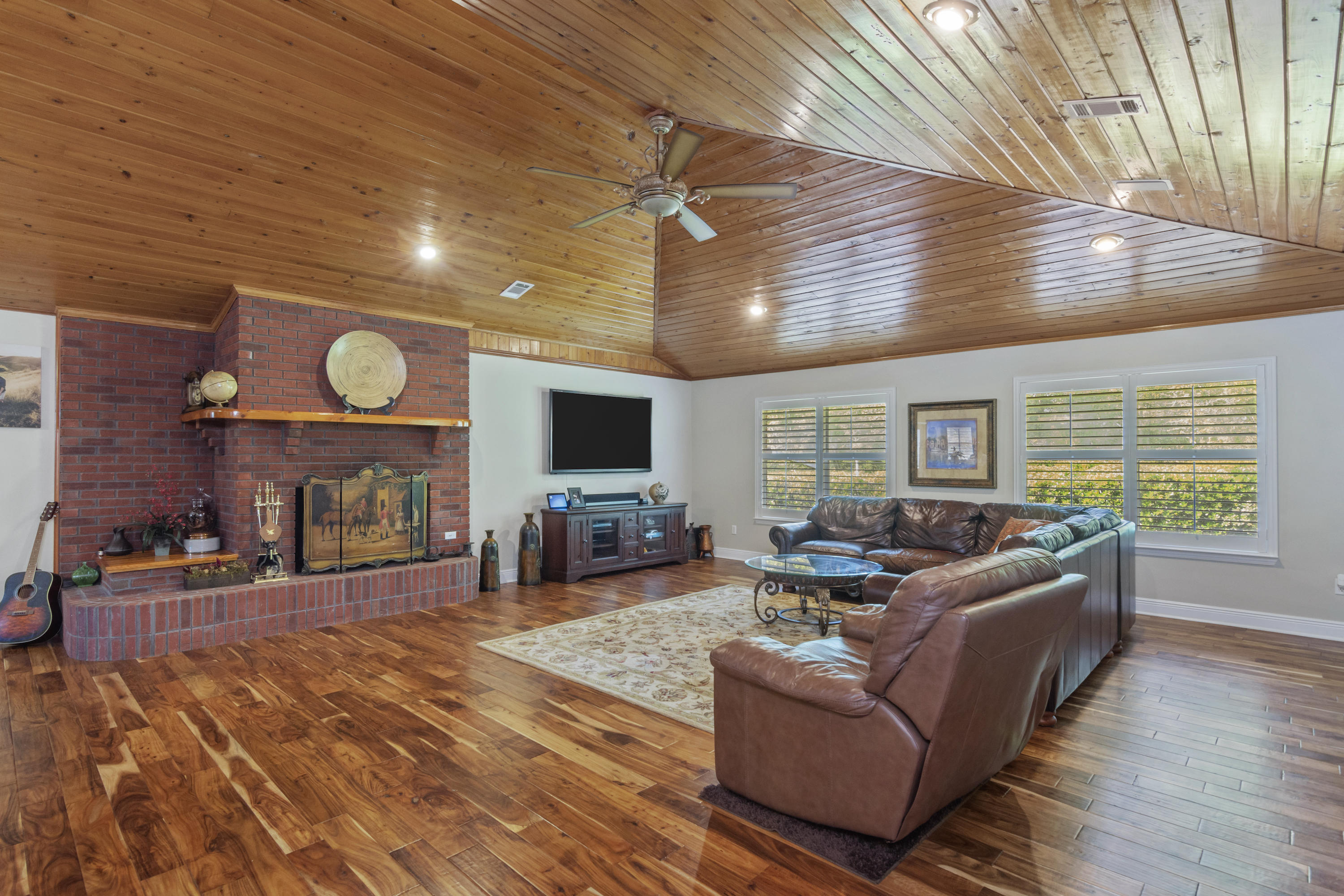 5766 Wildwood Road Crestview, FL 32536 - Photo 11 of 45 a living room with furniture and a flat screen tv