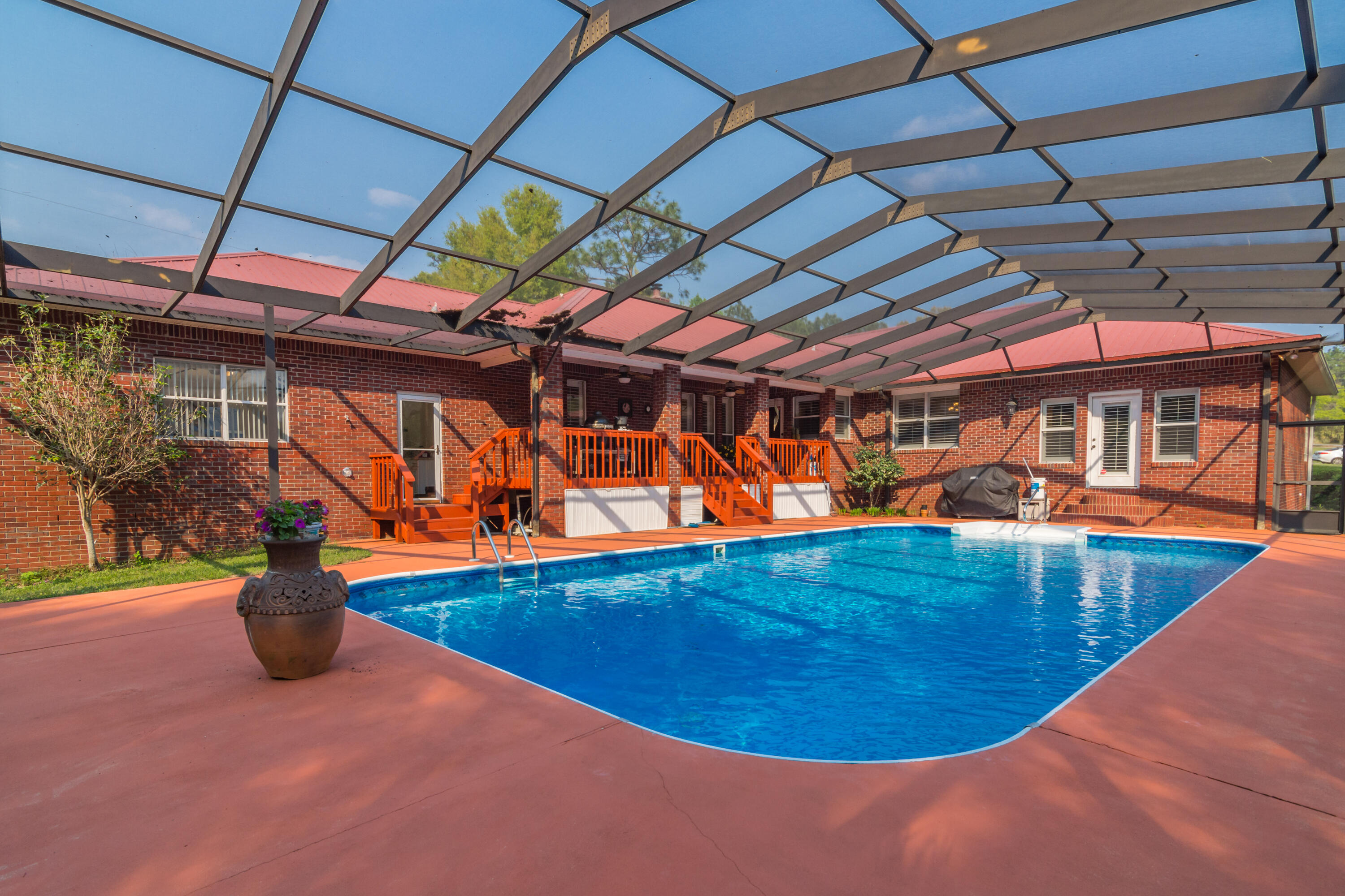 5766 Wildwood Road Crestview, FL 32536 - Photo 13 of 45 a view of a swimming pool with a patio