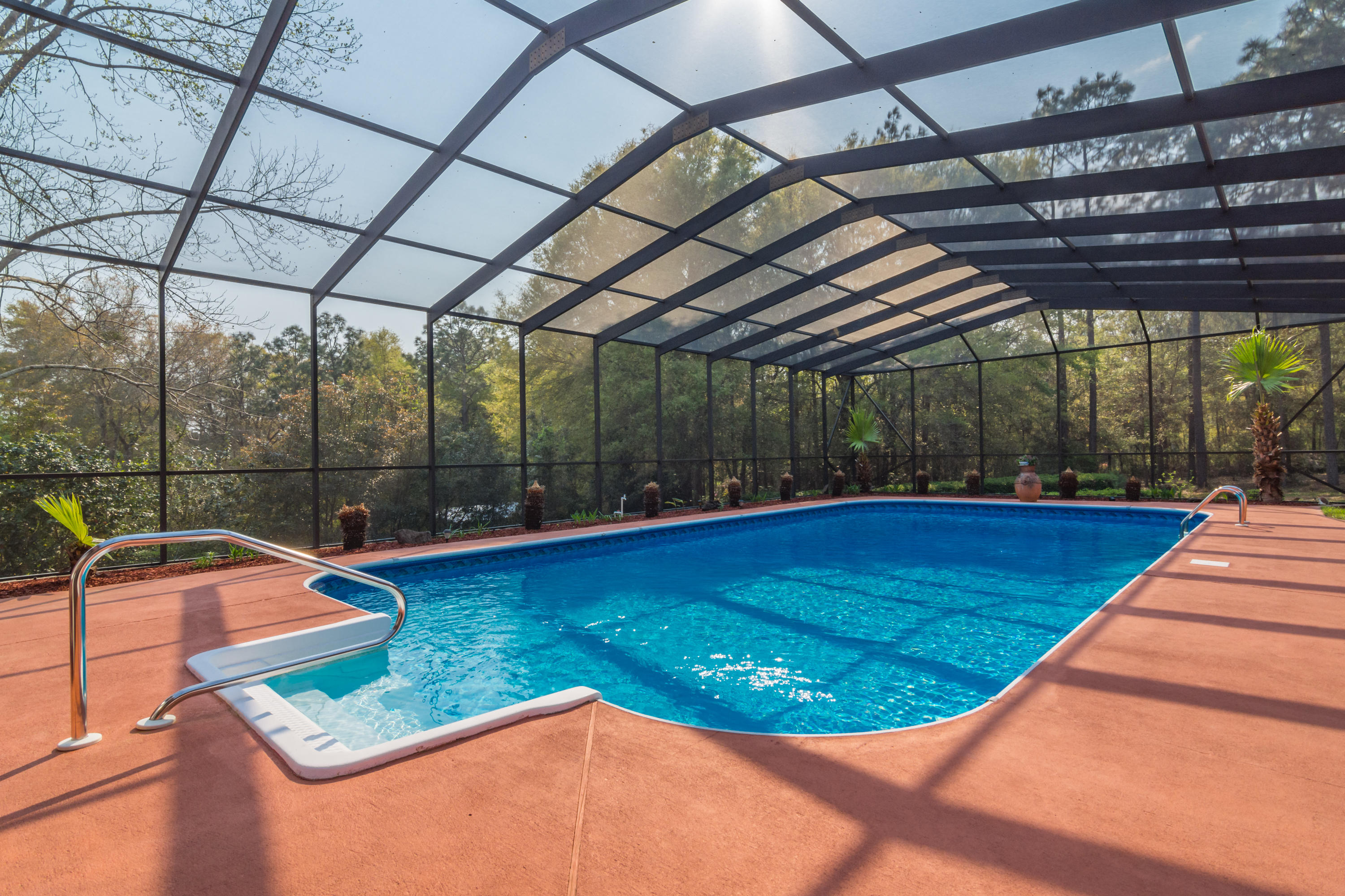 5766 Wildwood Road Crestview, FL 32536 - Photo 14 of 45 a view of a swimming pool with a patio
