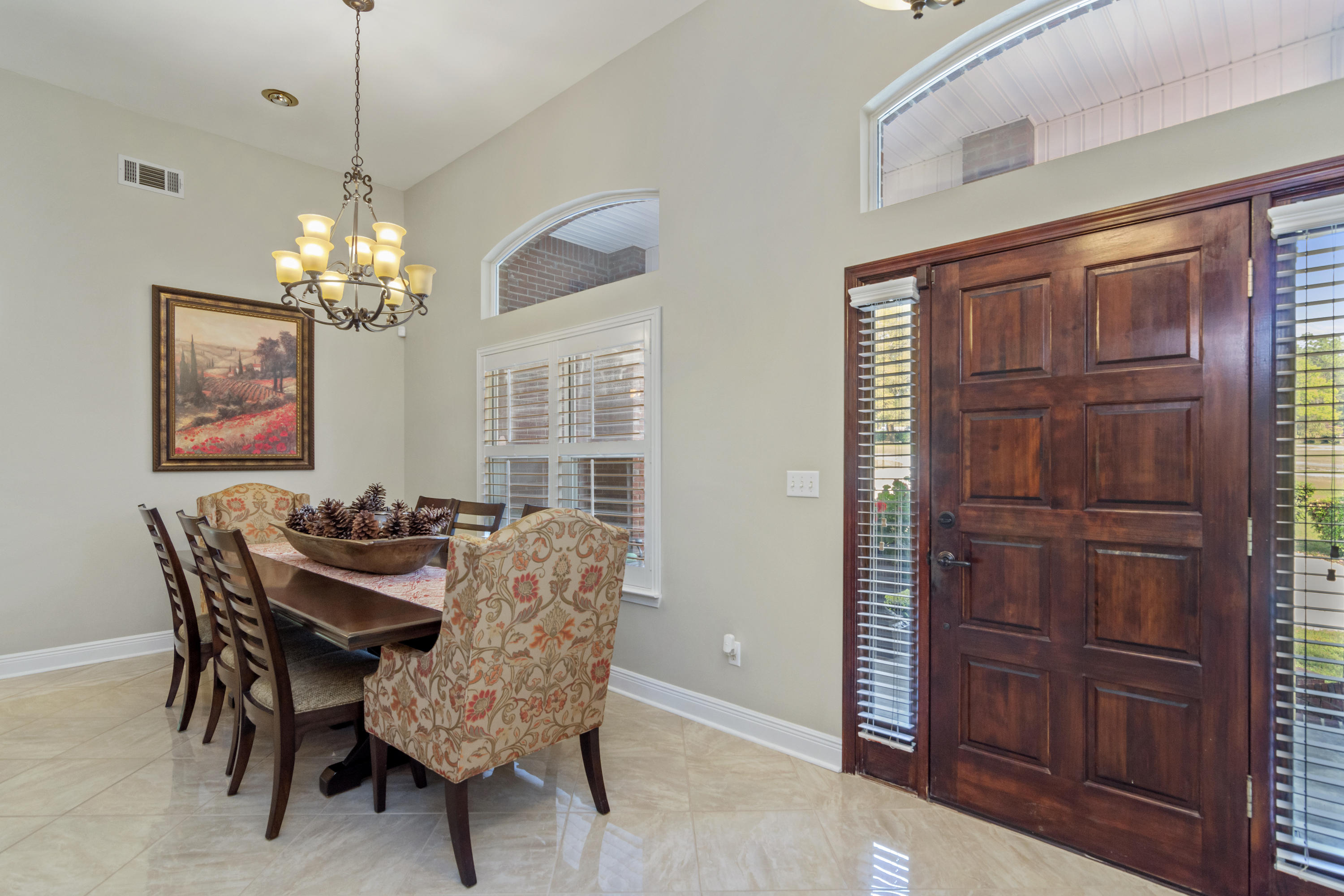 5766 Wildwood Road Crestview, FL 32536 - Photo 16 of 45 a dining room with furniture and chandelier