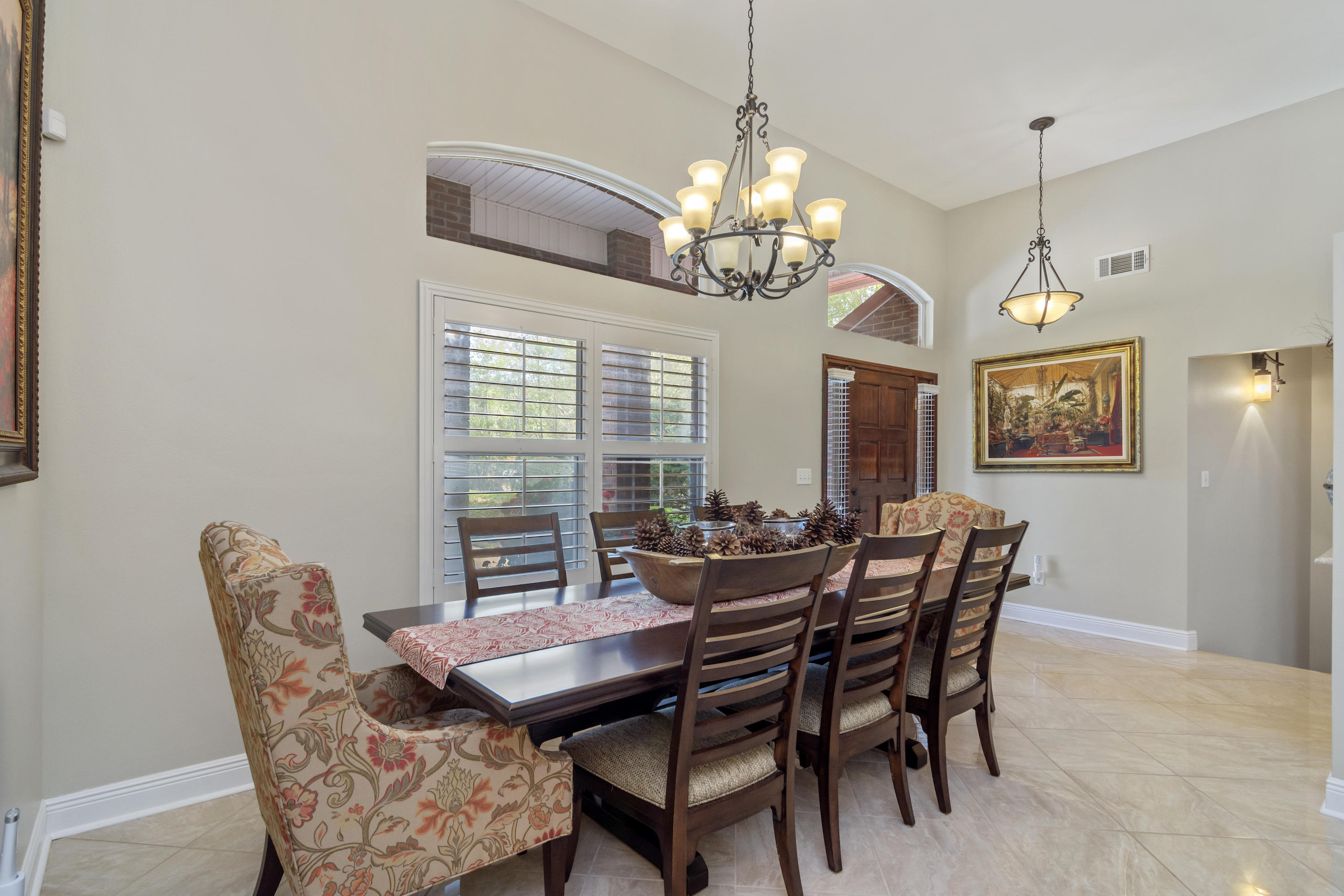 5766 Wildwood Road Crestview, FL 32536 - Photo 19 of 45 a view of a dining room with furniture a chandelier and window