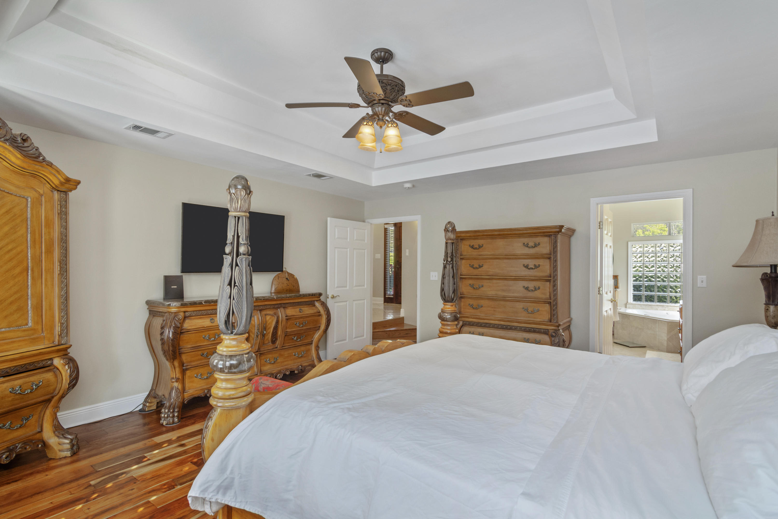 5766 Wildwood Road Crestview, FL 32536 - Photo 21 of 45 a bedroom with a bed and a chandelier