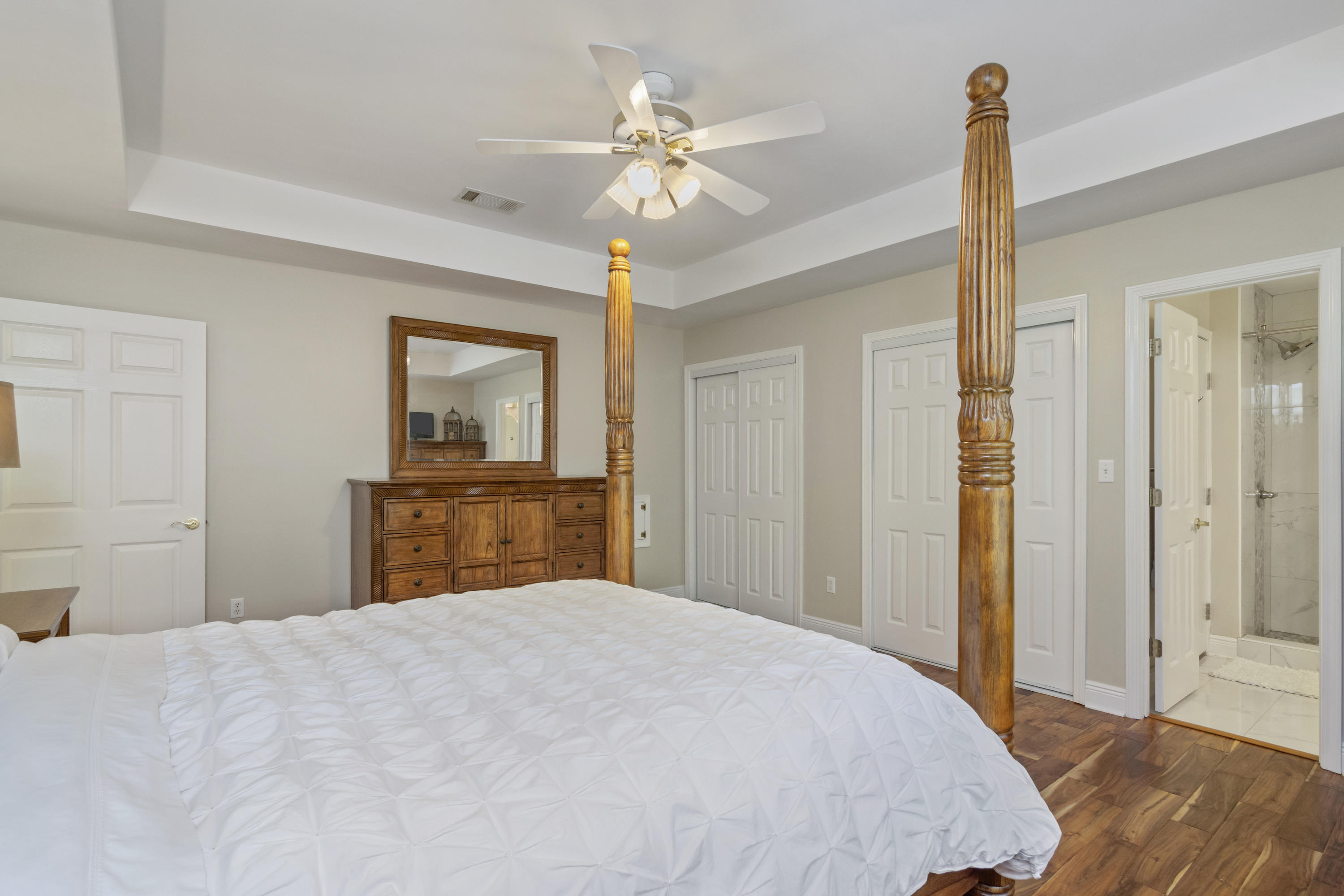 5766 Wildwood Road Crestview, FL 32536 - Photo 27 of 45 a bedroom with a bed and a chandelier