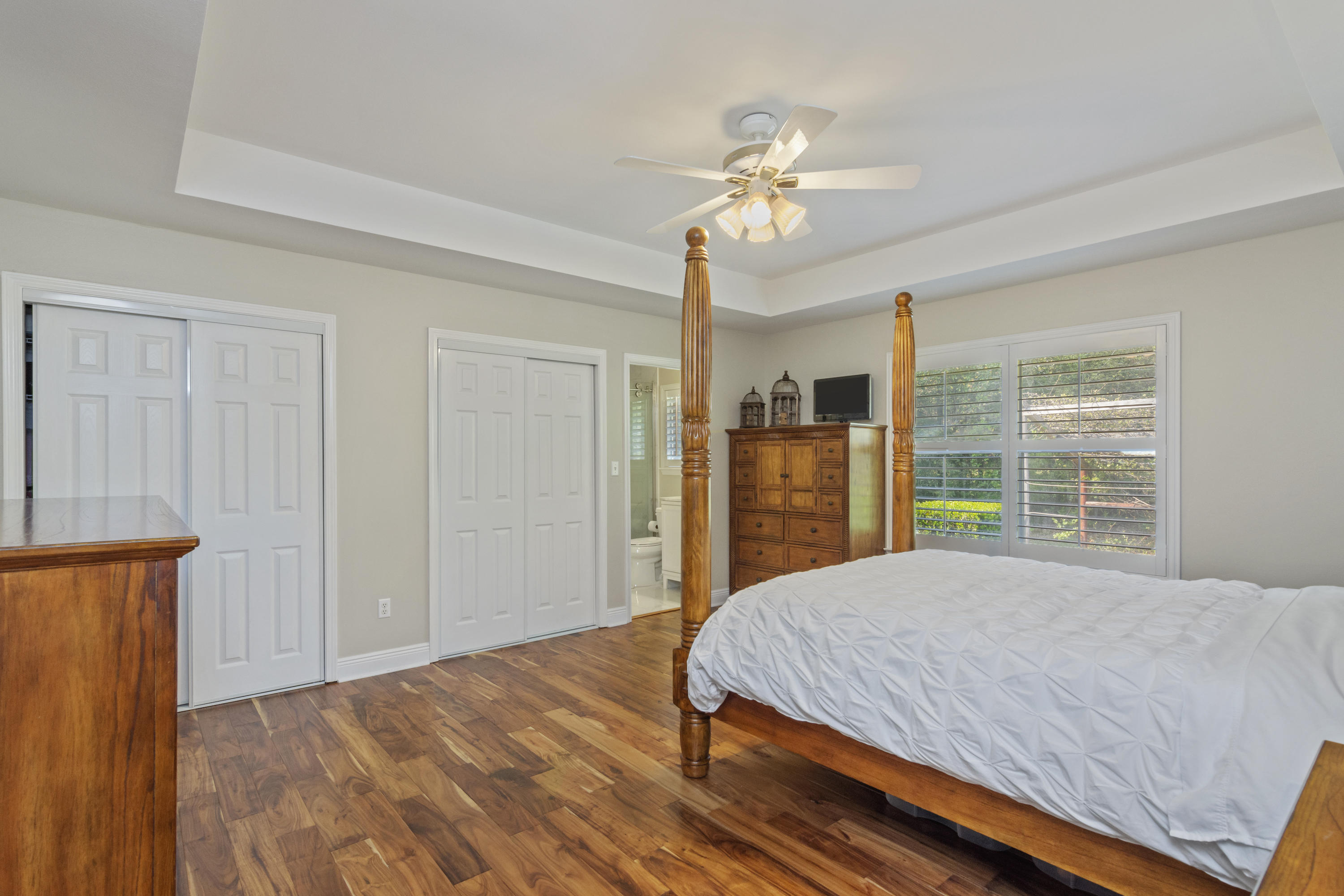 5766 Wildwood Road Crestview, FL 32536 - Photo 28 of 45 a bedroom with a large bed and a chandelier