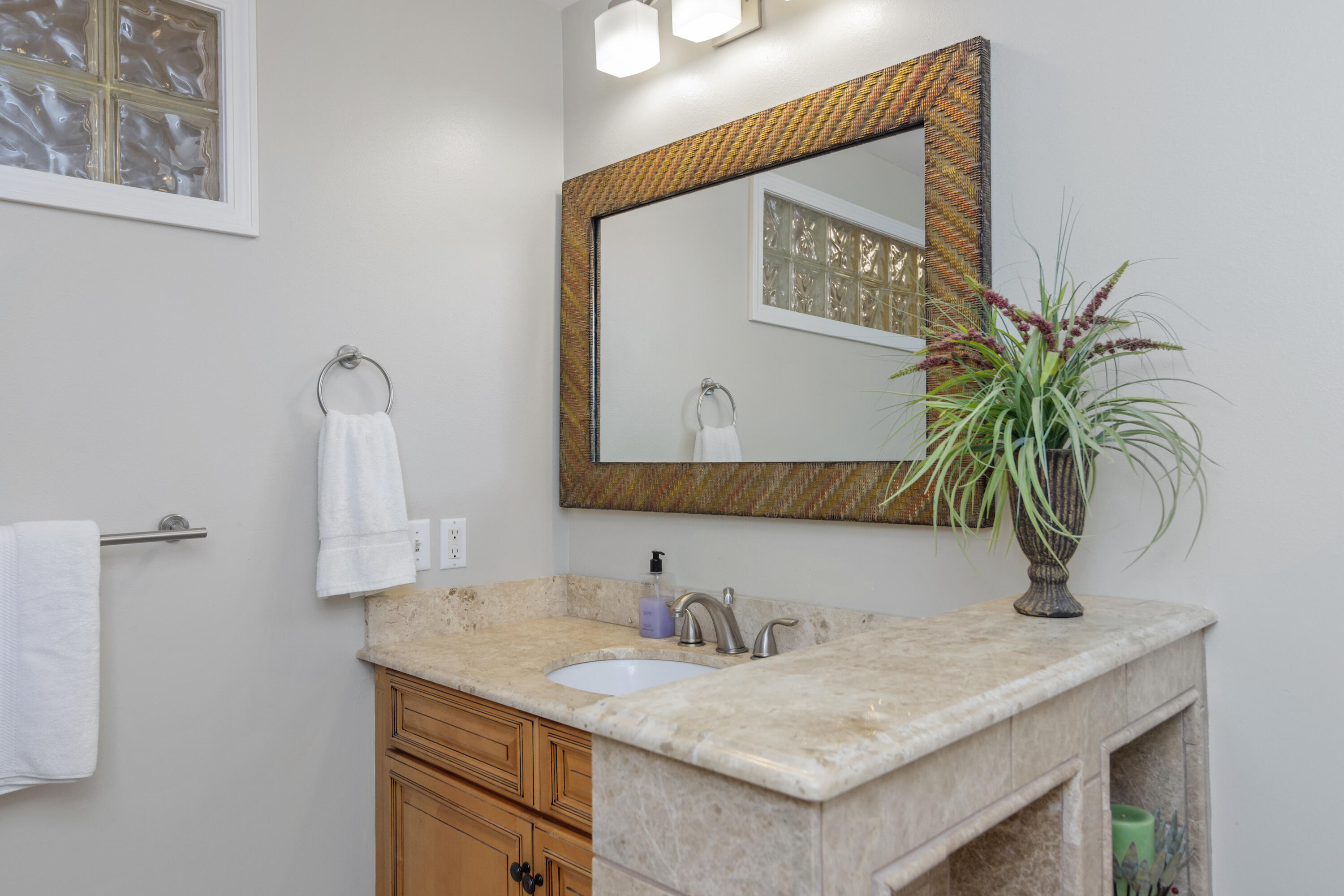 5766 Wildwood Road Crestview, FL 32536 - Photo 32 of 45 a bathroom with a granite countertop sink and a mirror