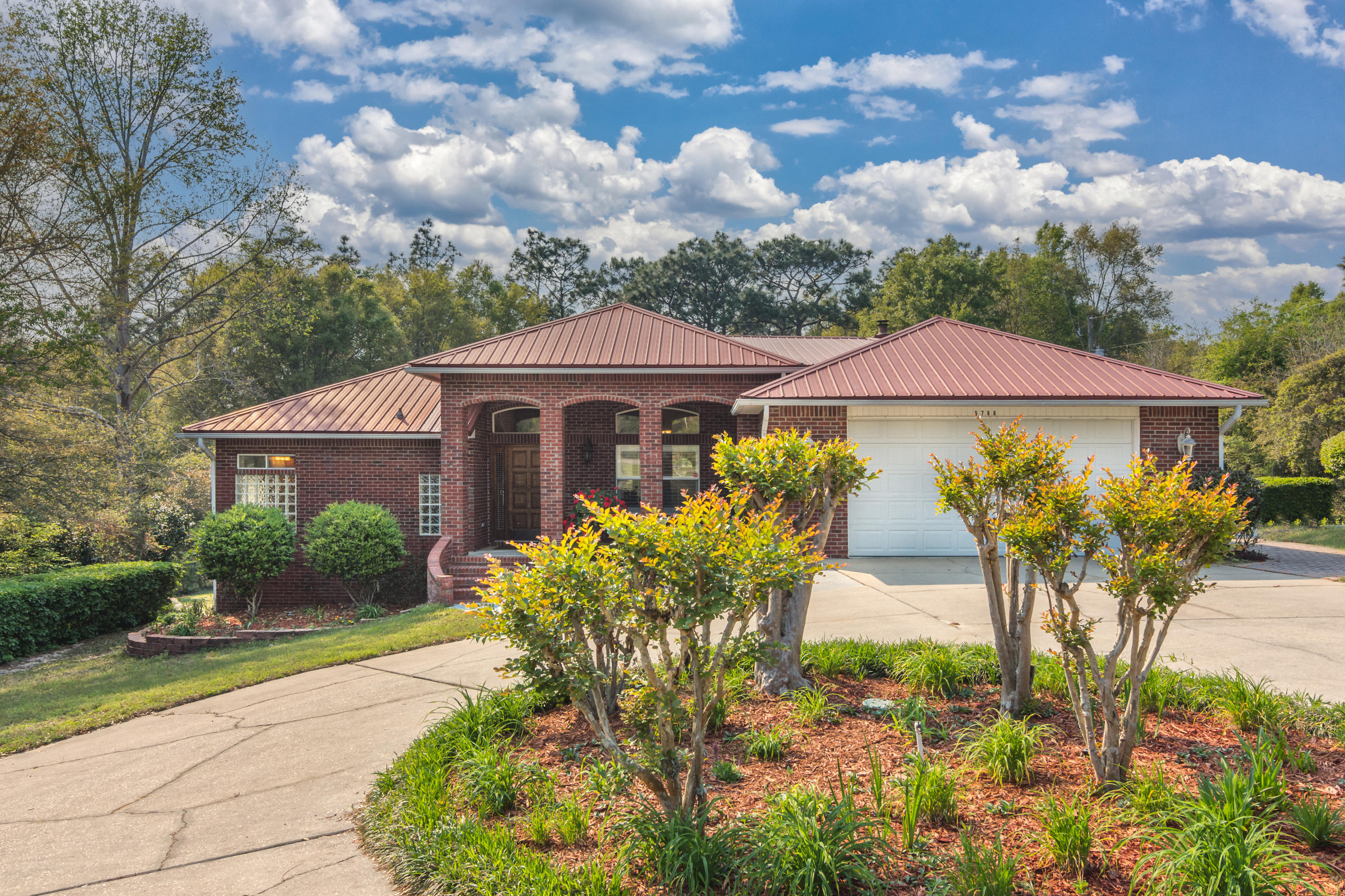 5766 Wildwood Road Crestview, FL 32536 - Photo 4 of 45 a front view of a house with garden