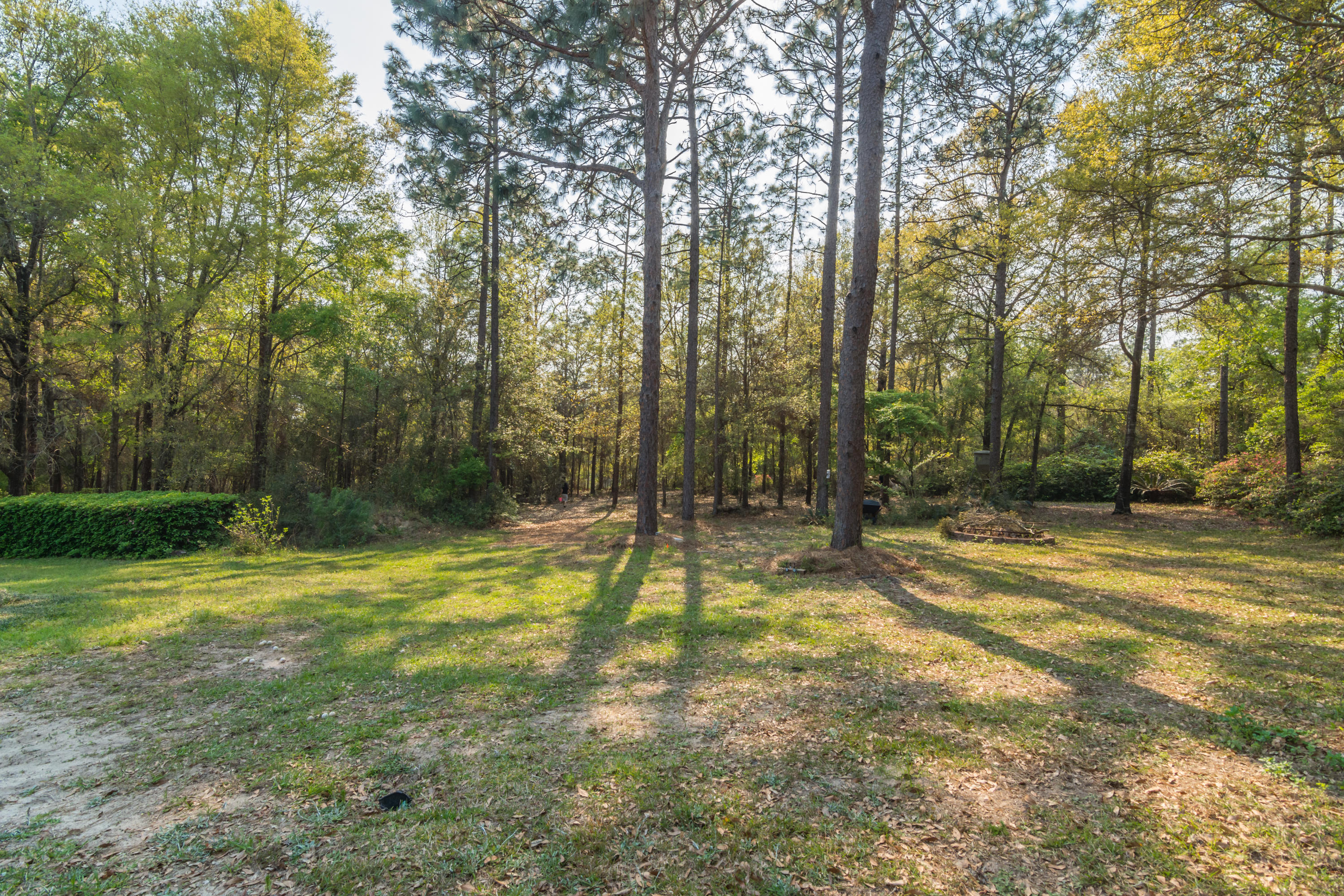 5766 Wildwood Road Crestview, FL 32536 - Photo 44 of 45 a swimming pool with trees in the background