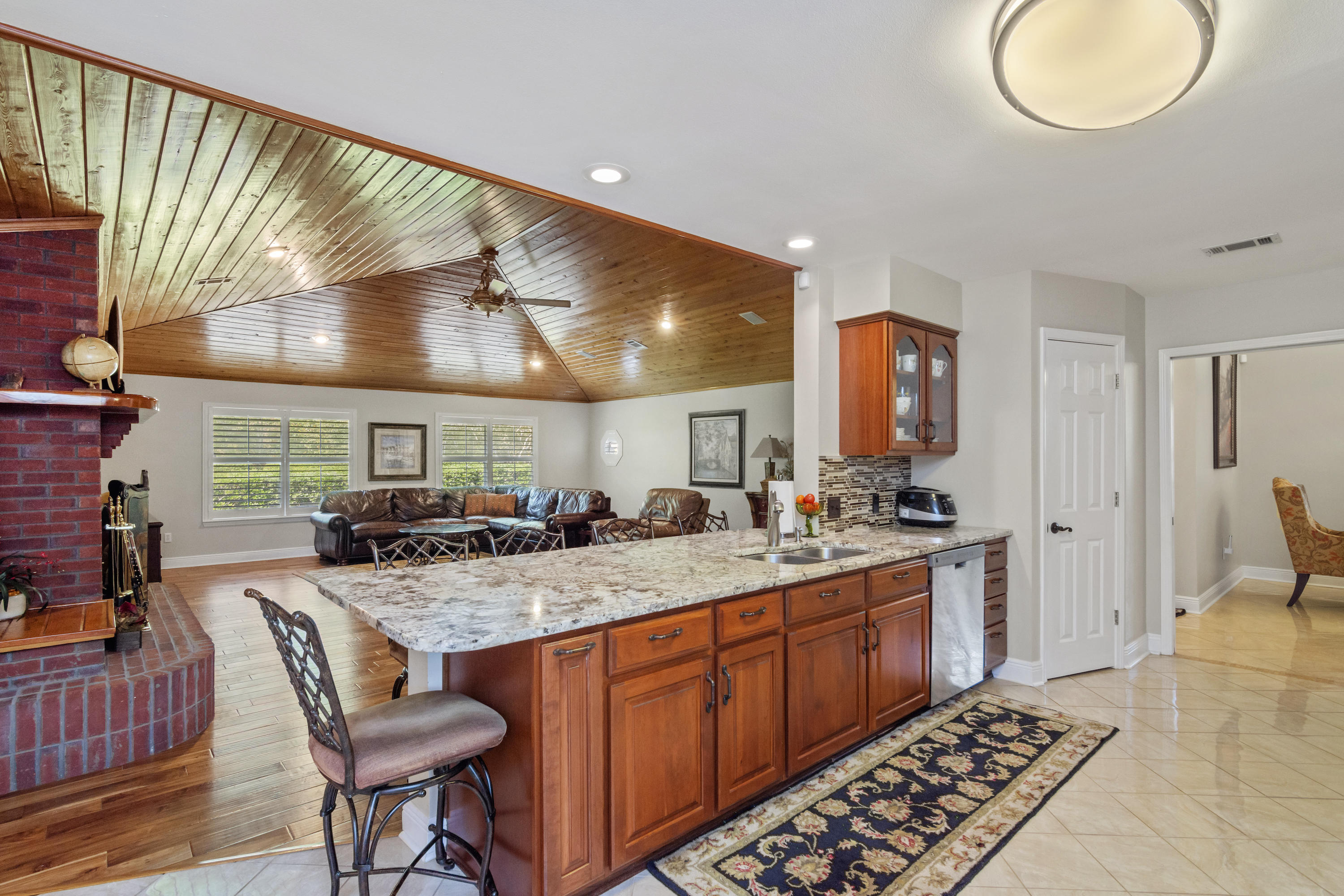 5766 Wildwood Road Crestview, FL 32536 - Photo 5 of 45 a kitchen with a sink a stove and chairs