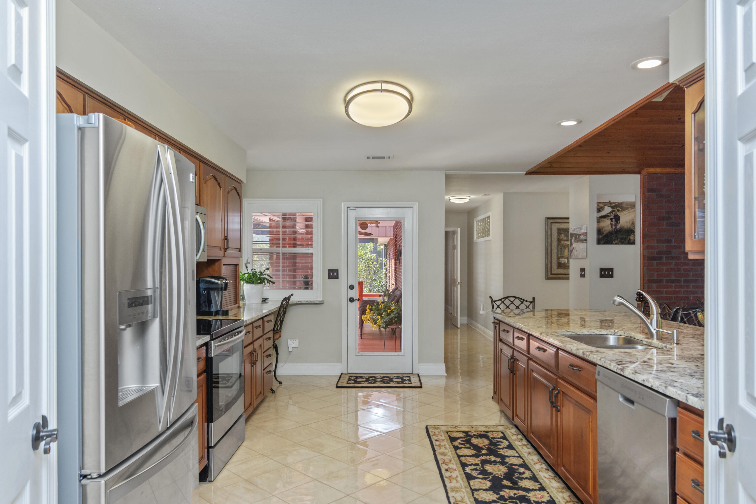 5766 Wildwood Road Crestview, FL 32536 - Photo 8 of 45 a kitchen with stainless steel appliances granite countertop a refrigerator and a sink