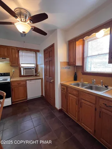 a kitchen with a sink window and cabinets
