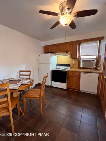 a view of a kitchen with a stove and a chandelier