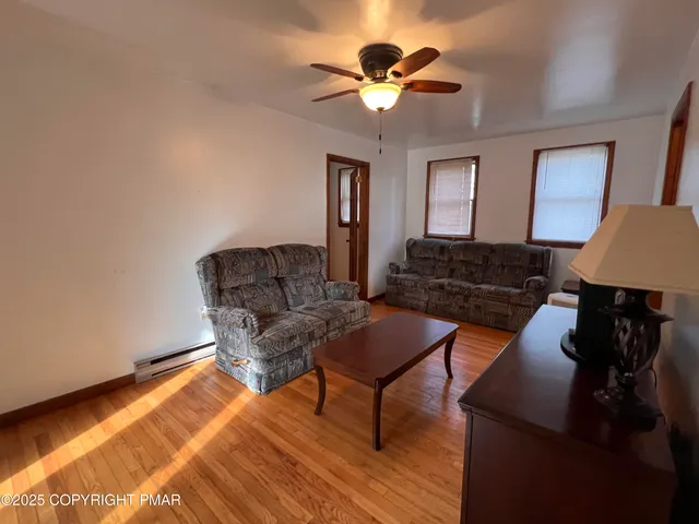 a living room with furniture and a lamp