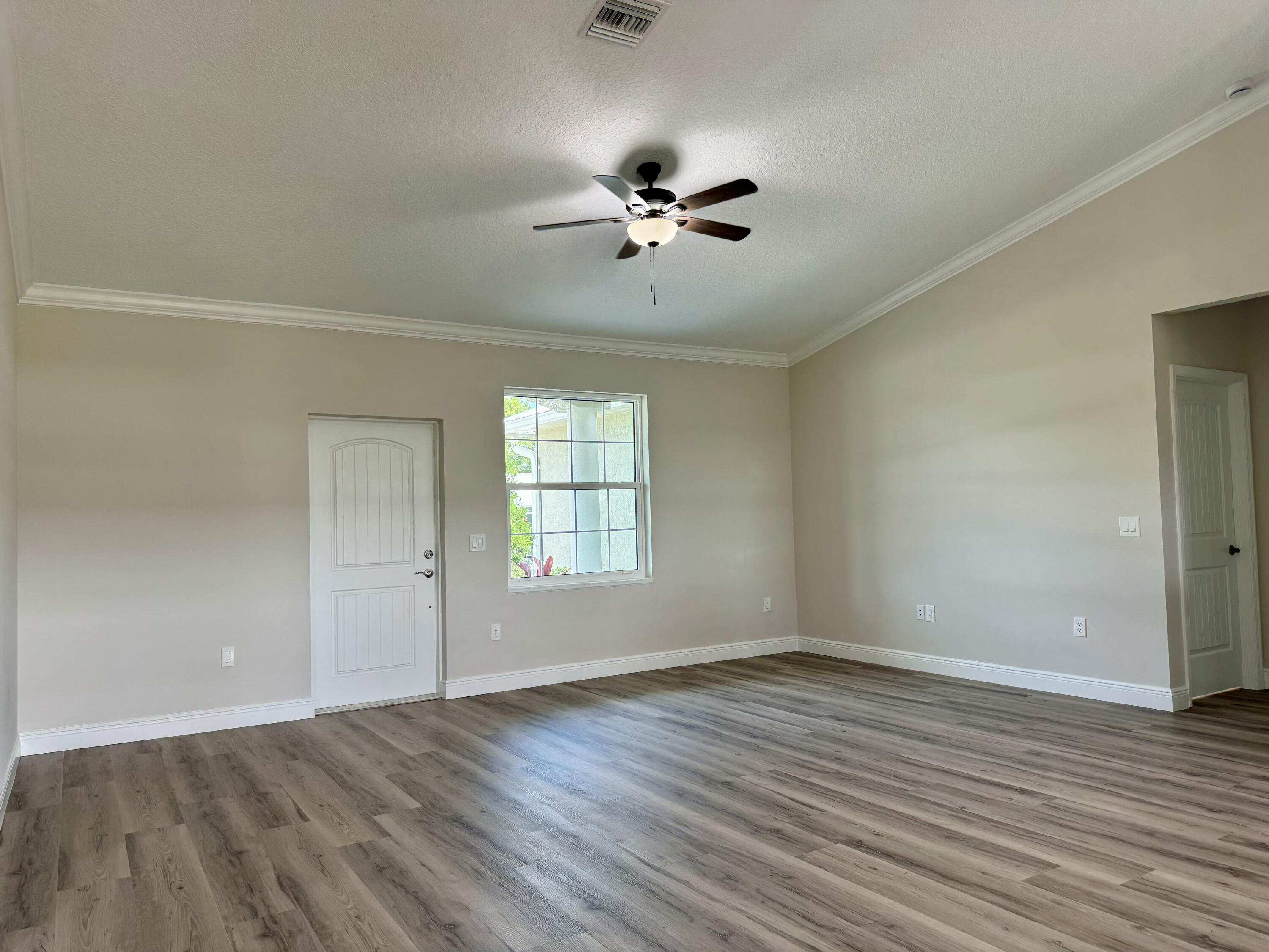 553 Southeast 36th Terrace Okeechobee, FL 34974 - Photo 2 of 21 wooden floor in an empty room with a window