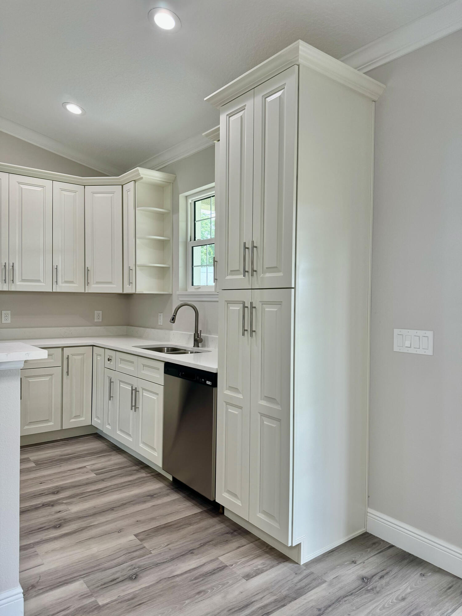 553 Southeast 36th Terrace Okeechobee, FL 34974 - Photo 5 of 21 a kitchen with granite countertop white cabinets and stainless steel appliances