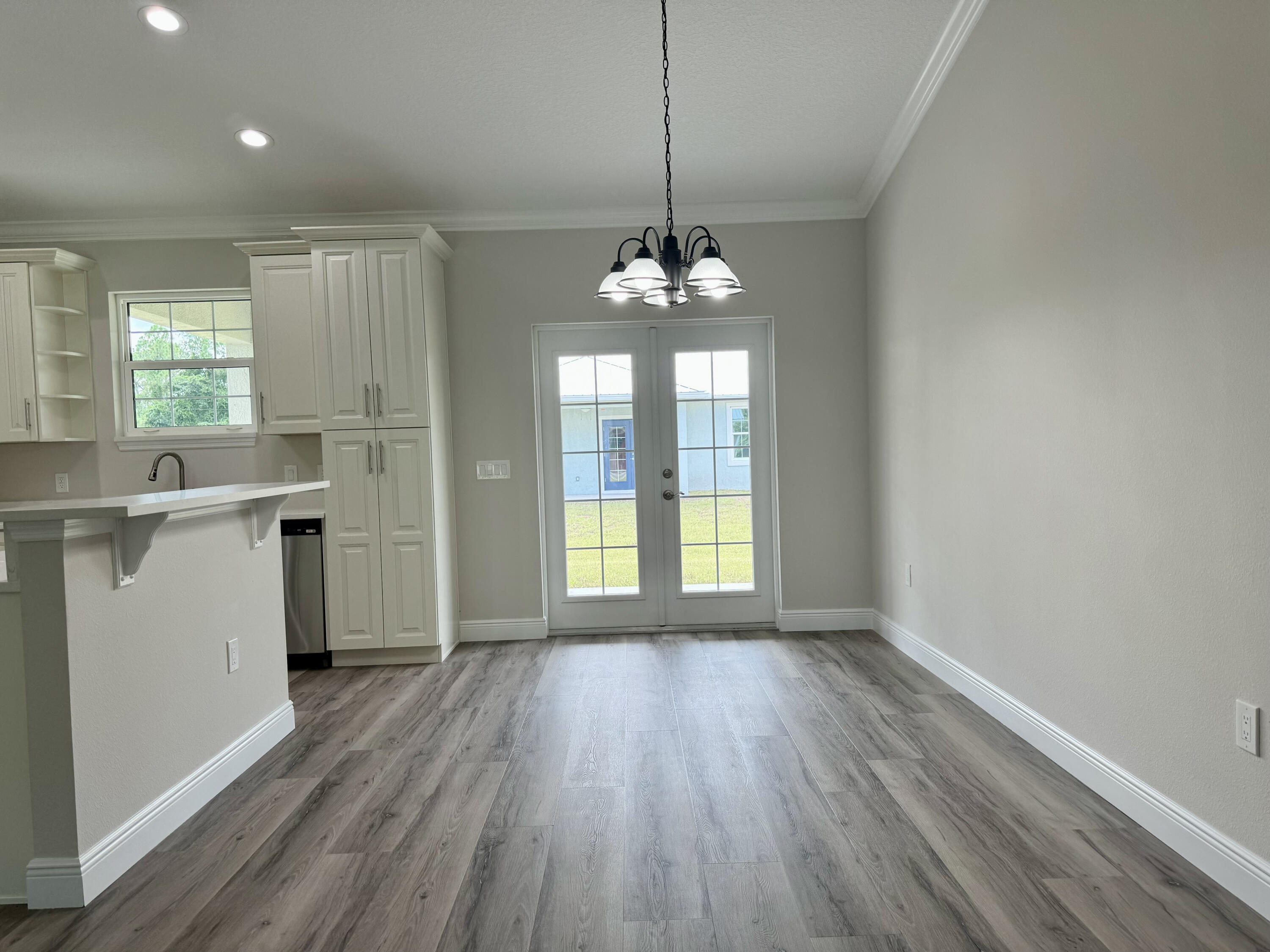 553 Southeast 36th Terrace Okeechobee, FL 34974 - Photo 7 of 21 a view of a kitchen with a sink wooden floor and a window