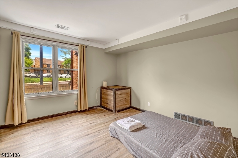 1475 Mt Holly Road, Unit 4 Edgewater Park, NJ 08010 - Photo 16 of 18 a bedroom with a bed and wooden floor