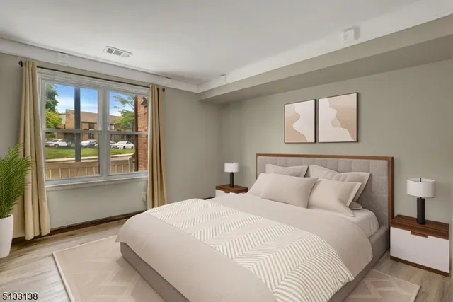 a bedroom with a large bed and a large window