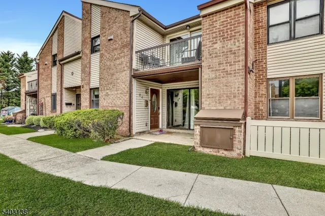 a front view of a house with a yard and fence