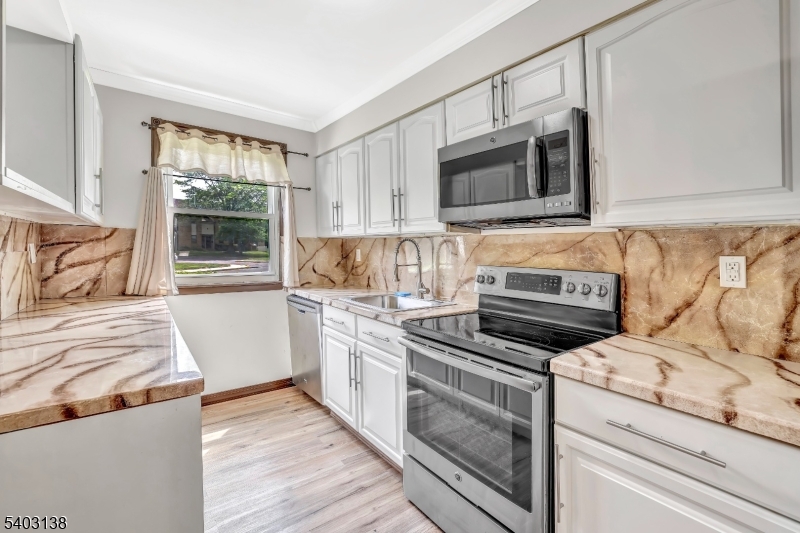 1475 Mt Holly Road, Unit 4 Edgewater Park, NJ 08010 - Photo 3 of 18 a kitchen with a stove and a microwave