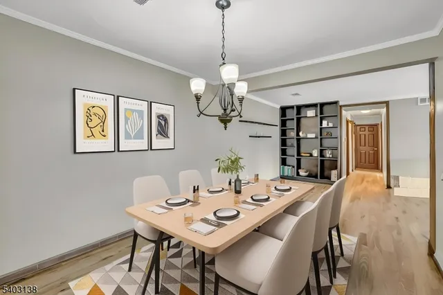 a view of a dining room with a table and chairs