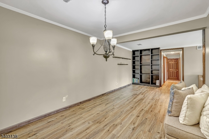 1475 Mt Holly Road, Unit 4 Edgewater Park, NJ 08010 - Photo 7 of 18 a view of a livingroom with a chandelier fan and wooden floor