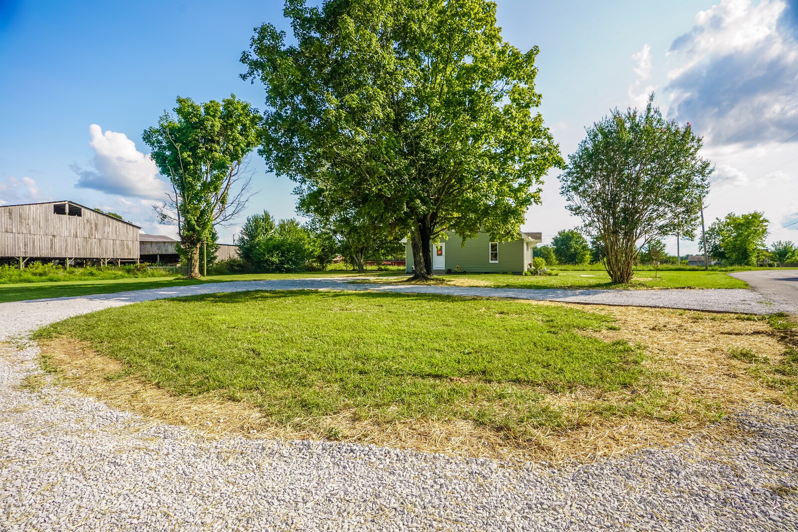 150 Absher Road Portland, TN 37148 - Photo 37 of 37 a view of a house with a big yard and palm trees