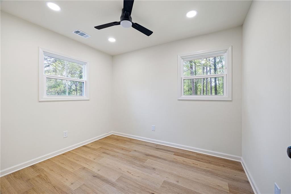 4289 Kimball Road Southwest Atlanta, GA 30331 - Photo 15 of 20 an empty room with wooden floor and windows