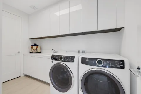 a view of storage and utility room with washer and dryer