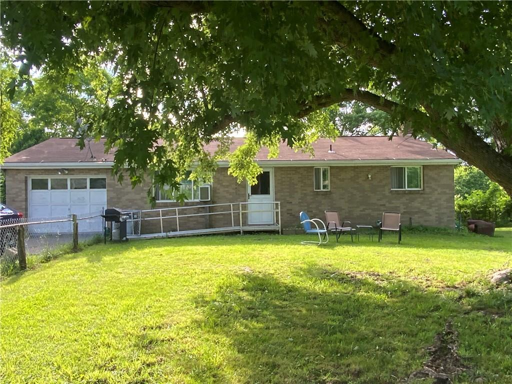 a view of a house with swimming pool and sitting area