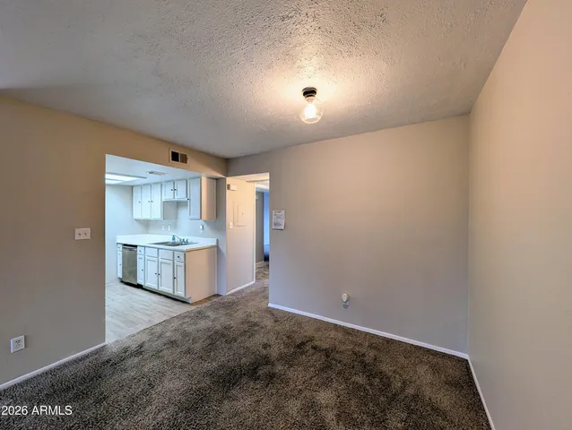 a view of a kitchen with a sink and cabinets