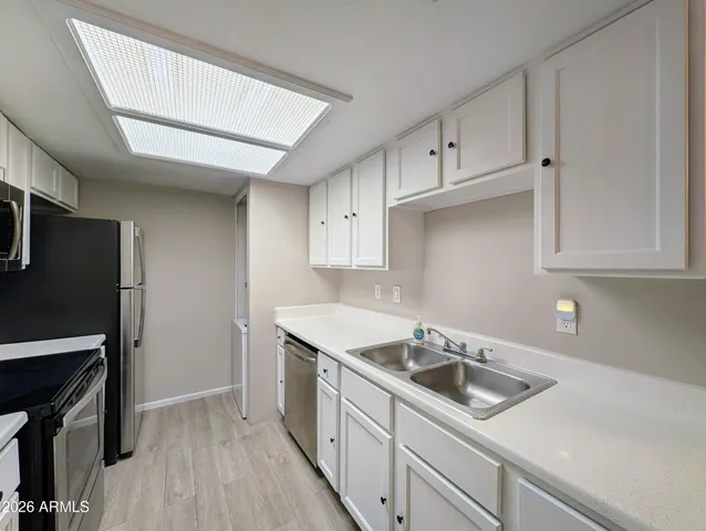 a kitchen that has a sink and a stove