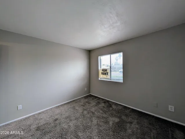 a view of an empty room and closet area