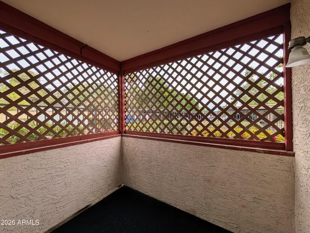 a view of swimming pool with a yard and palm trees