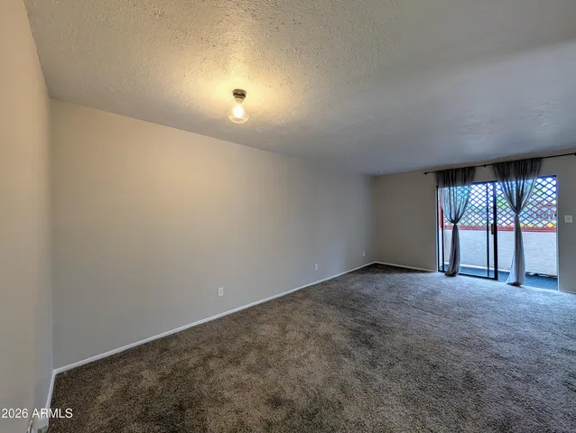 an empty room with windows and entrance