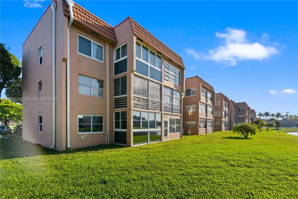 a view of an apartment with a backyard