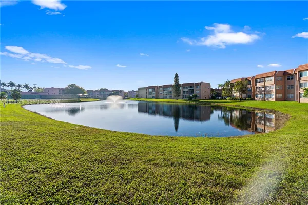 a view of a lake with houses in the background