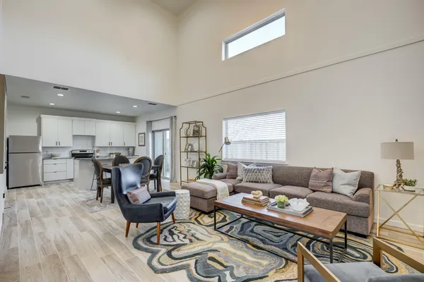 a living room with furniture and wooden floor