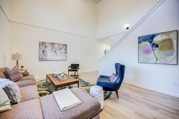 a kitchen with granite countertop white cabinets and stainless steel appliances