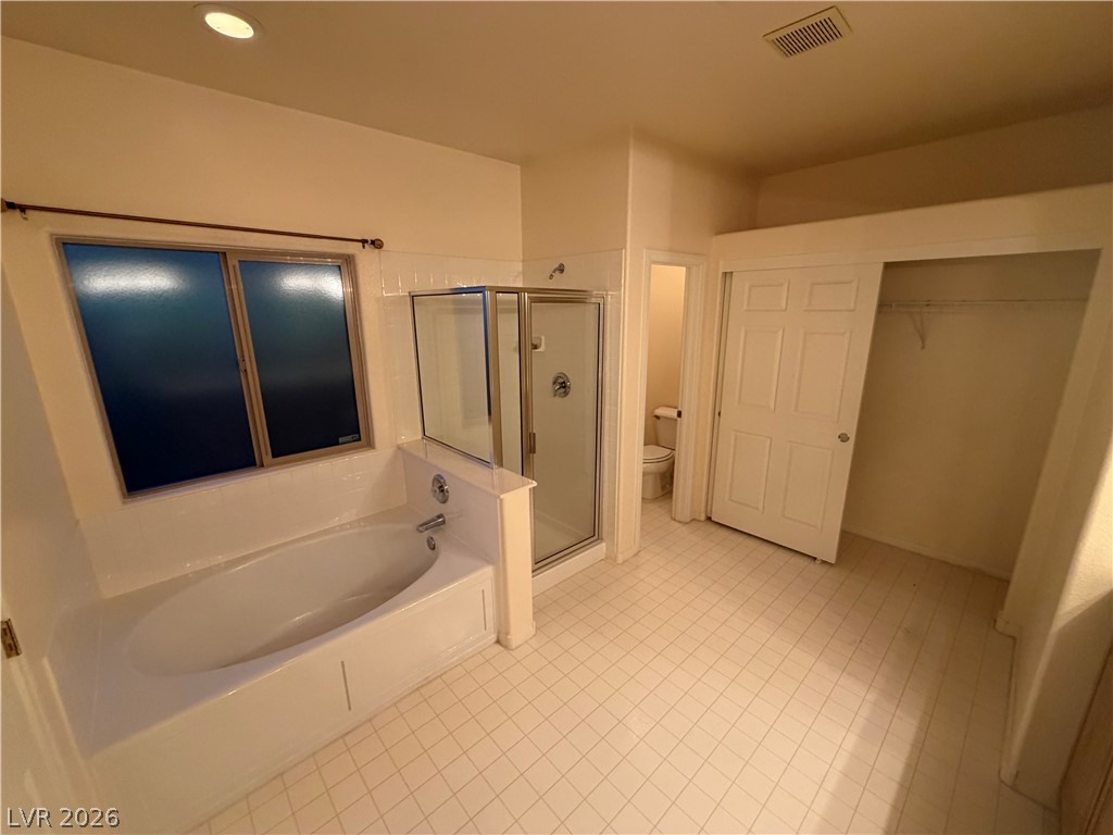7629 Rory Court Las Vegas, NV 89129 - Photo 13 of 25 Relax in the deep soaking tub, complemented by a convenient glass-enclosed shower and ample closet space.