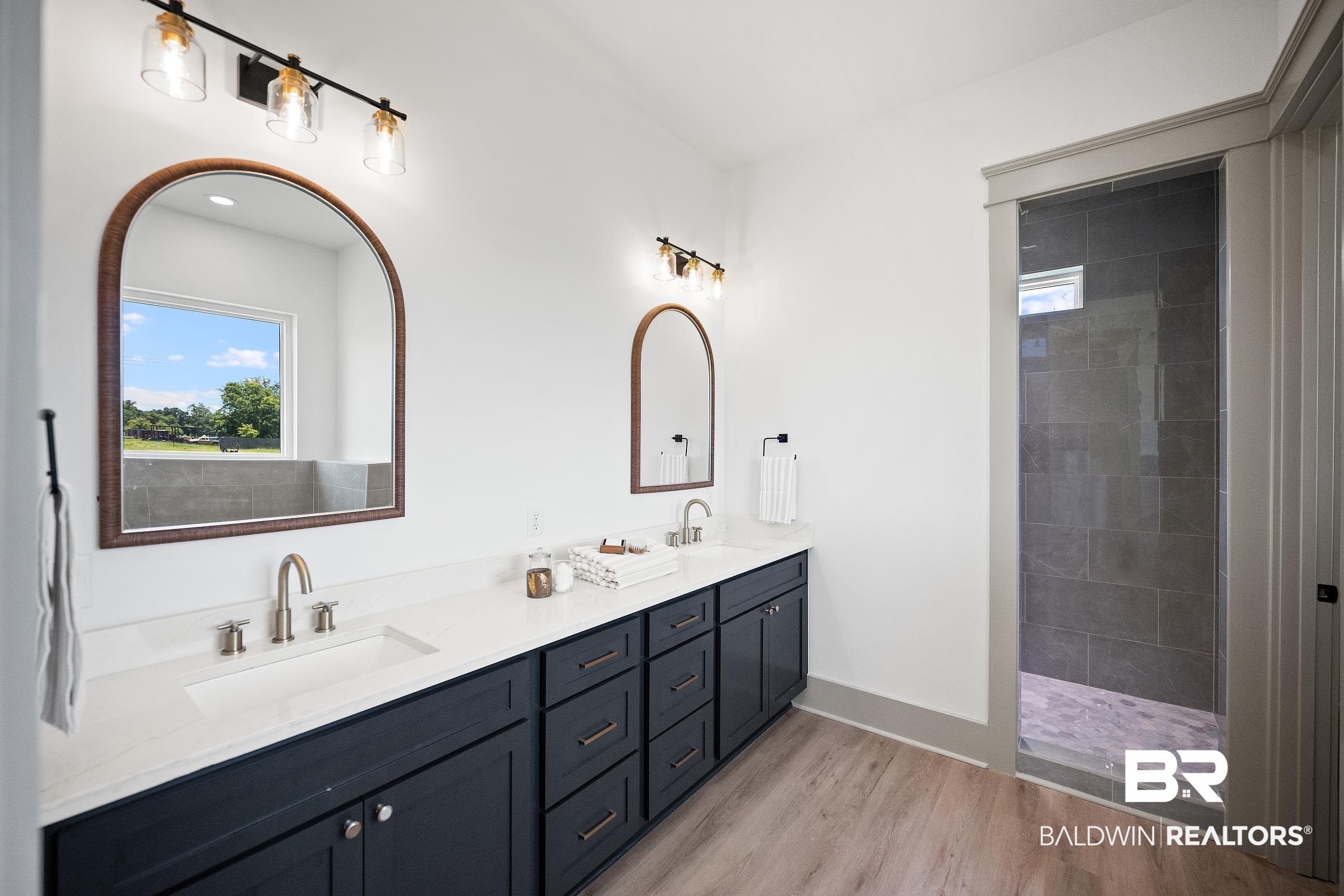 13111 Gopher Court Elberta, AL 36530 - Photo 16 of 41 Dual vanity with white countertops, dark cabinetry, and brushed nickel fixtures
