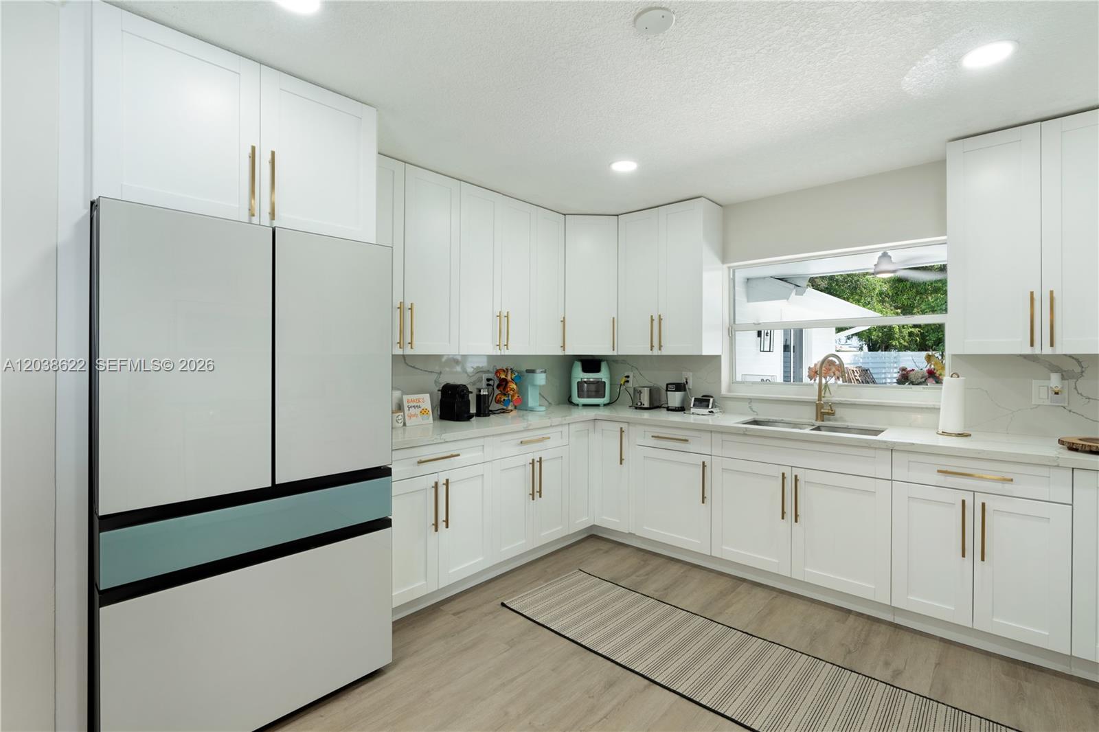 14830 Southwest 149th Street Miami, FL 33196 - Photo 8 of 43 a kitchen with white cabinets and white appliances