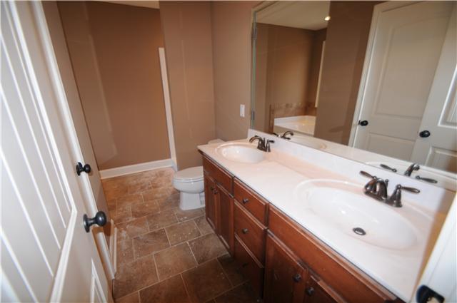 123 Legends Ridge Drive, Unit 12 Lebanon, TN 37090 - Photo 7 of 13 Master bath with double vanity and tile flooring.