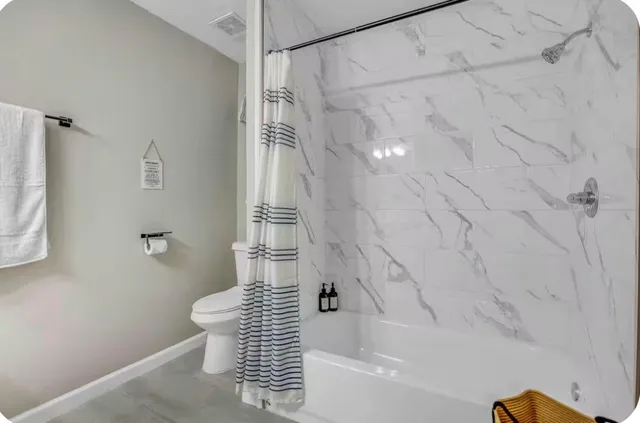 a bathroom with a bathtub and shower