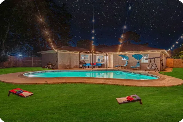 a yellow and red umbrella sitting in a yard