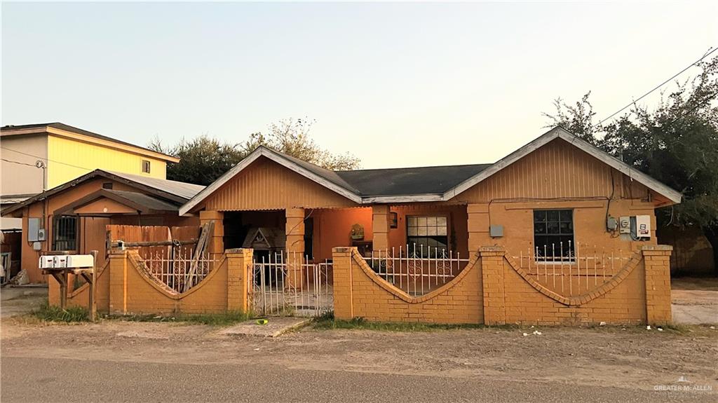 View of front facade with a fenced front yard and a gate