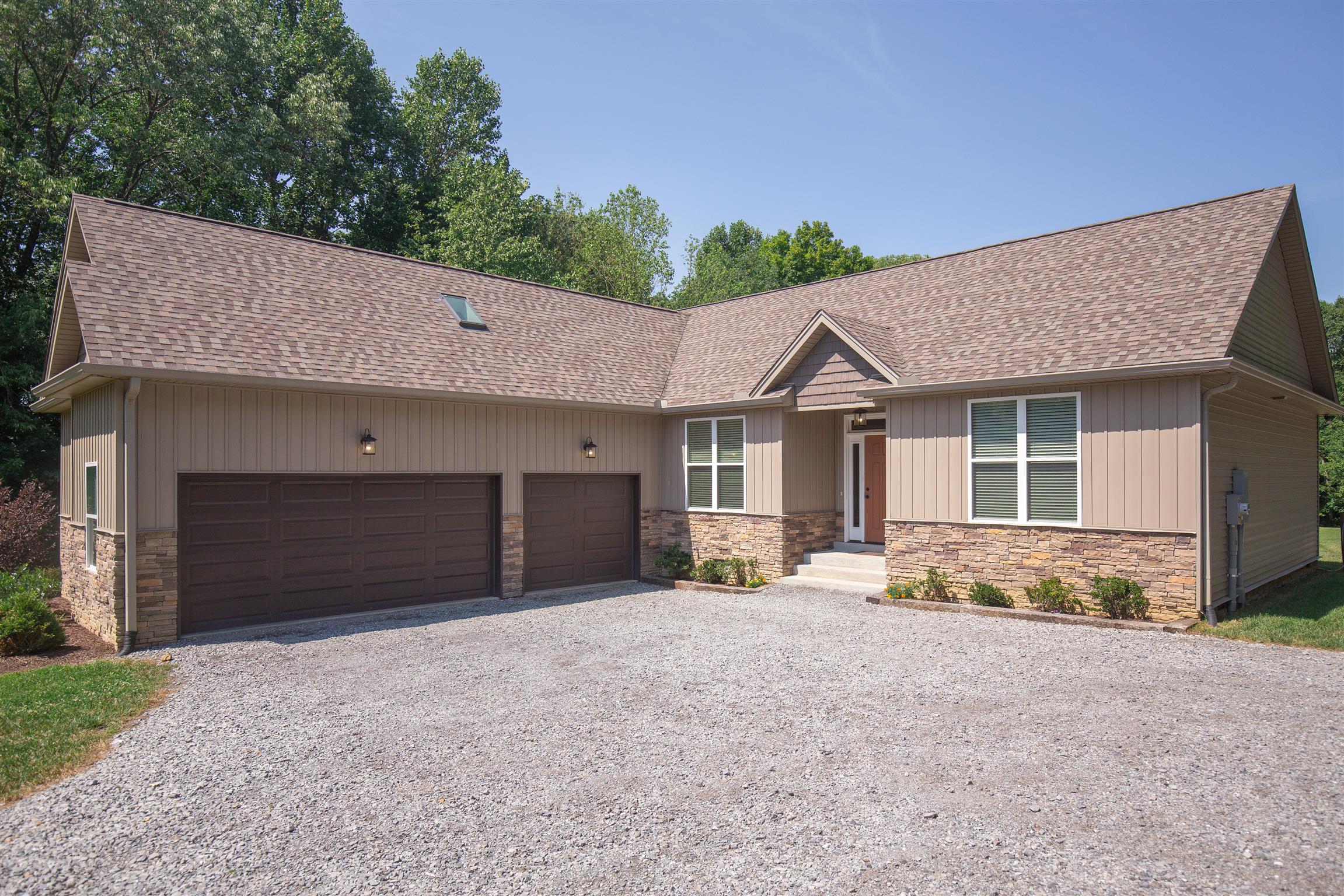 1045 North Corinth Road Portland, TN 37148 - Photo 1 of 29 a front view of a house with a yard and garage