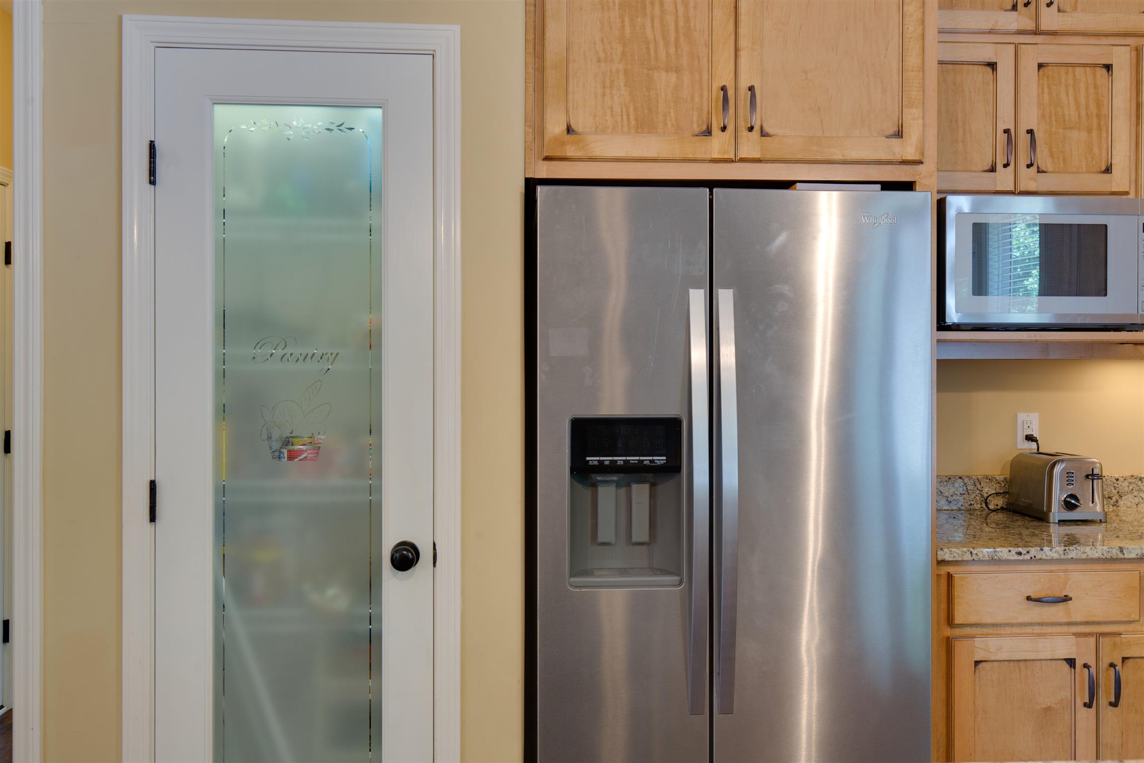 1045 North Corinth Road Portland, TN 37148 - Photo 11 of 29 a close view of a refrigerator in kitchen and cabinets