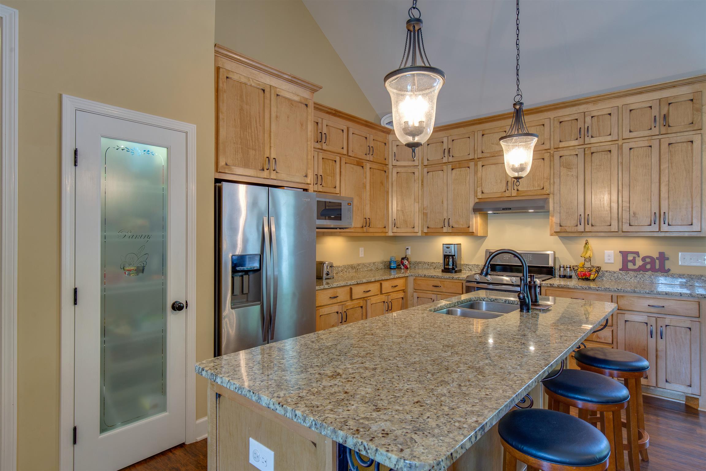 1045 North Corinth Road Portland, TN 37148 - Photo 12 of 29 a kitchen with granite countertop lots of counter top space refrigerator and cabinets
