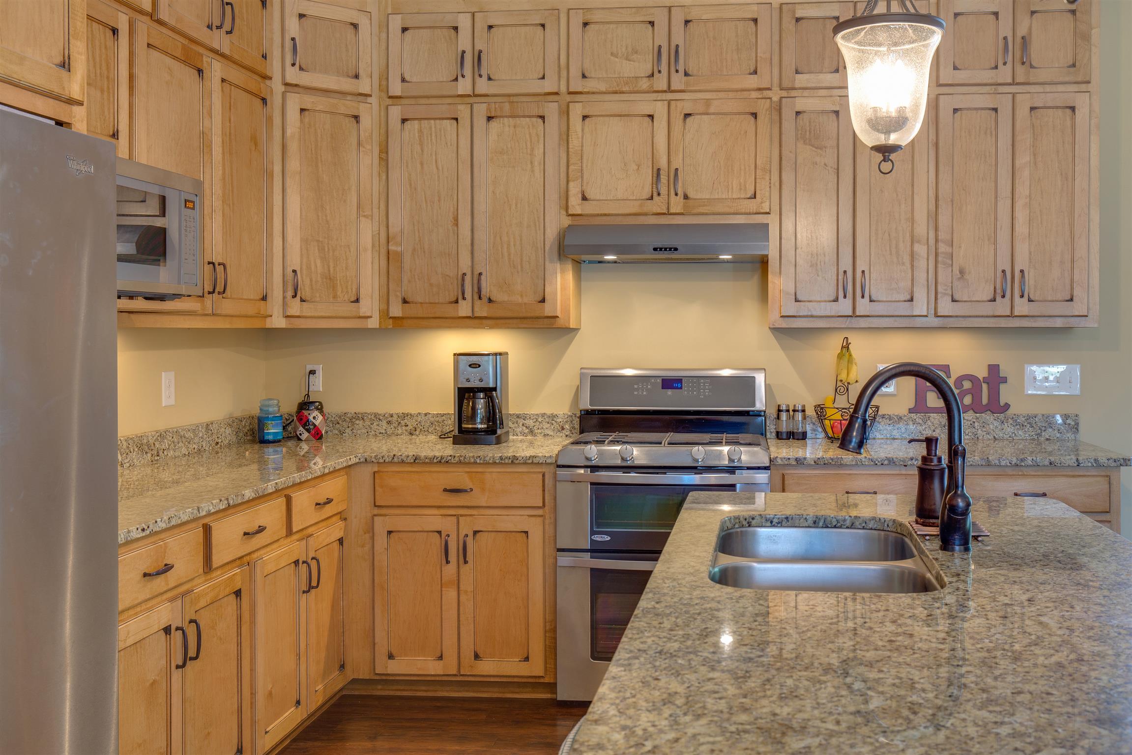 1045 North Corinth Road Portland, TN 37148 - Photo 13 of 29 a kitchen with granite countertop a sink stainless steel appliances and cabinets
